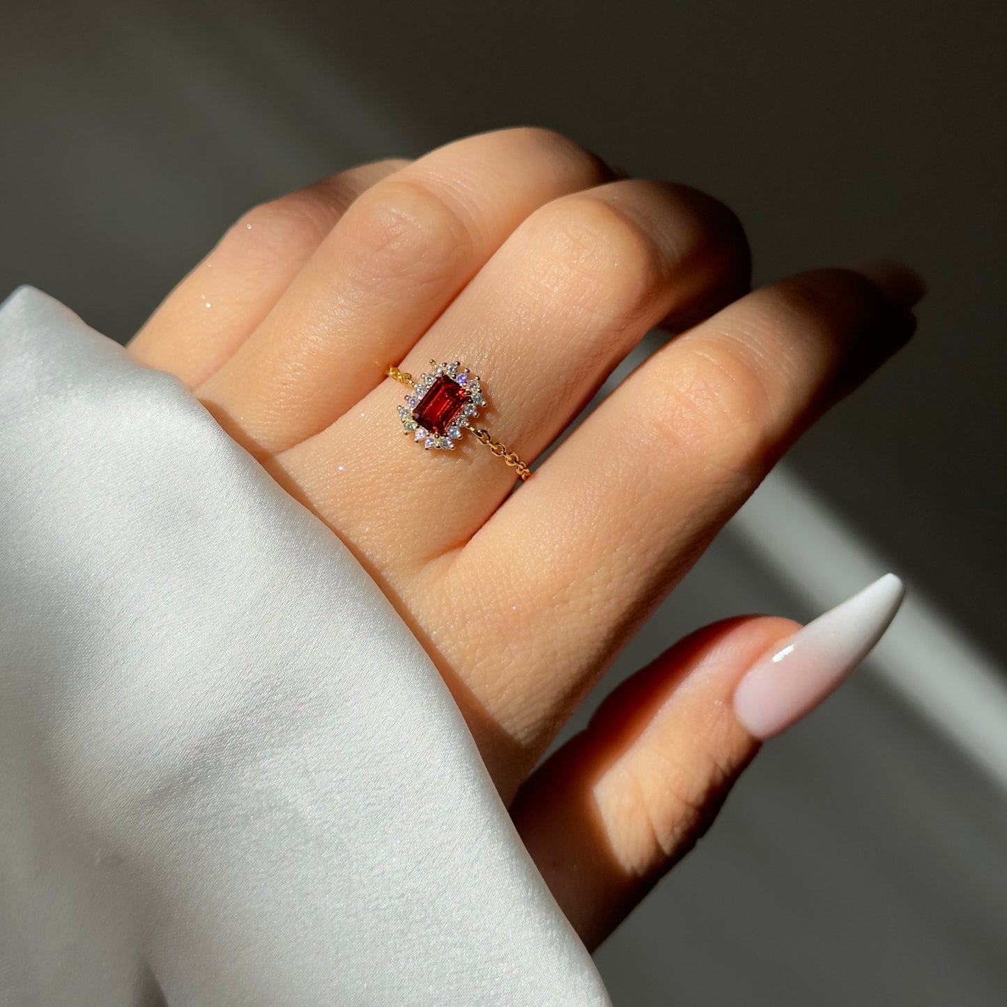 Adjustable vintage halo chain ring with emerald-cut stone
