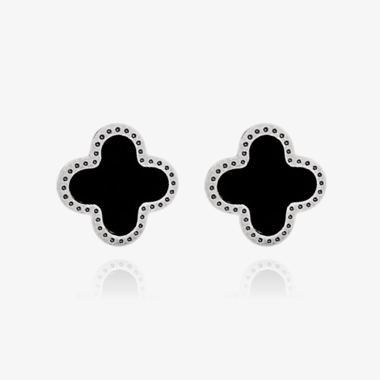 Black enamel clover earrings styled with minimalist outfit