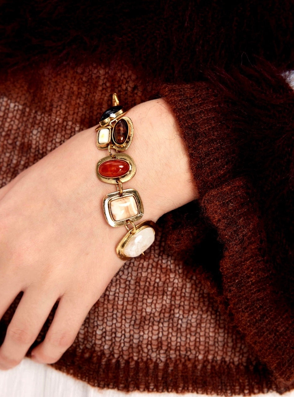 Close-up of gemstone bracelet with moonstone and tiger eye