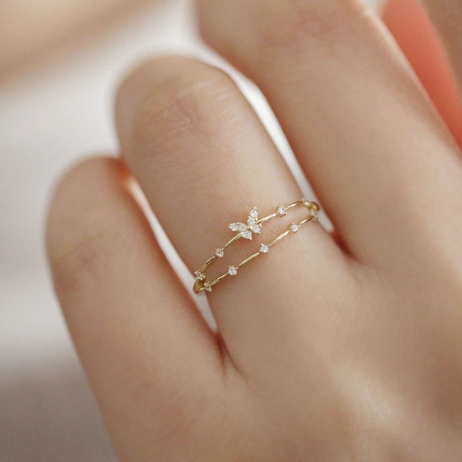 Dainty butterfly ring stacked with other rings