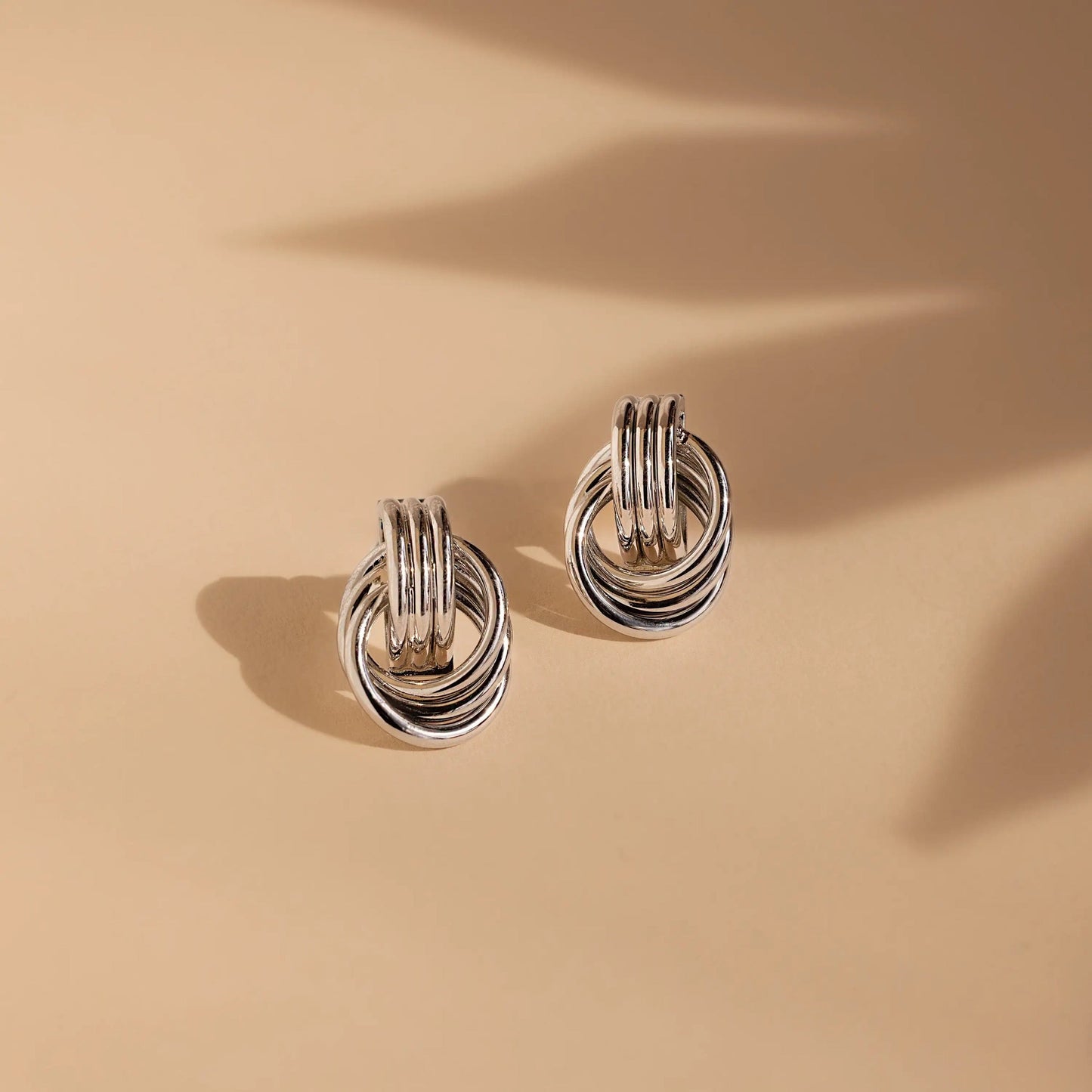 Clean Knot earrings styled for a nighttime elegant outfit