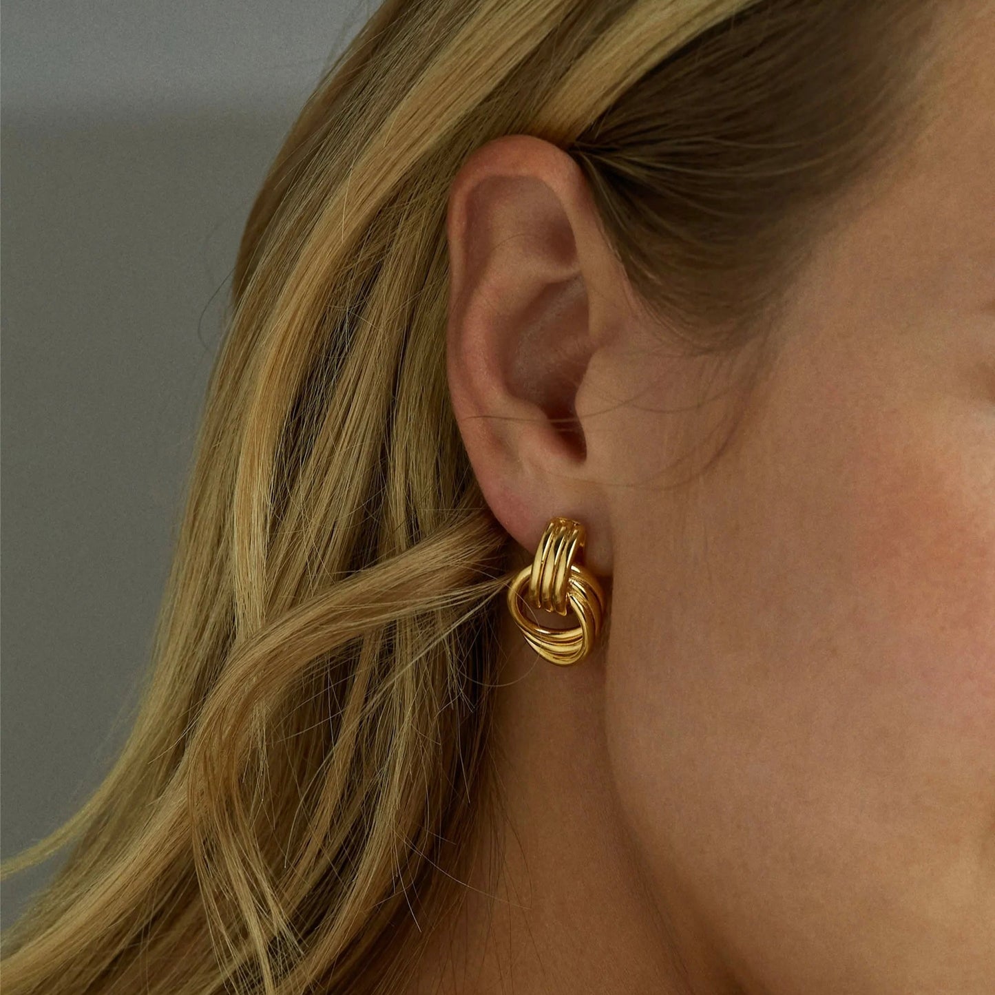 Clean Knot earrings styled with elegant office outfit