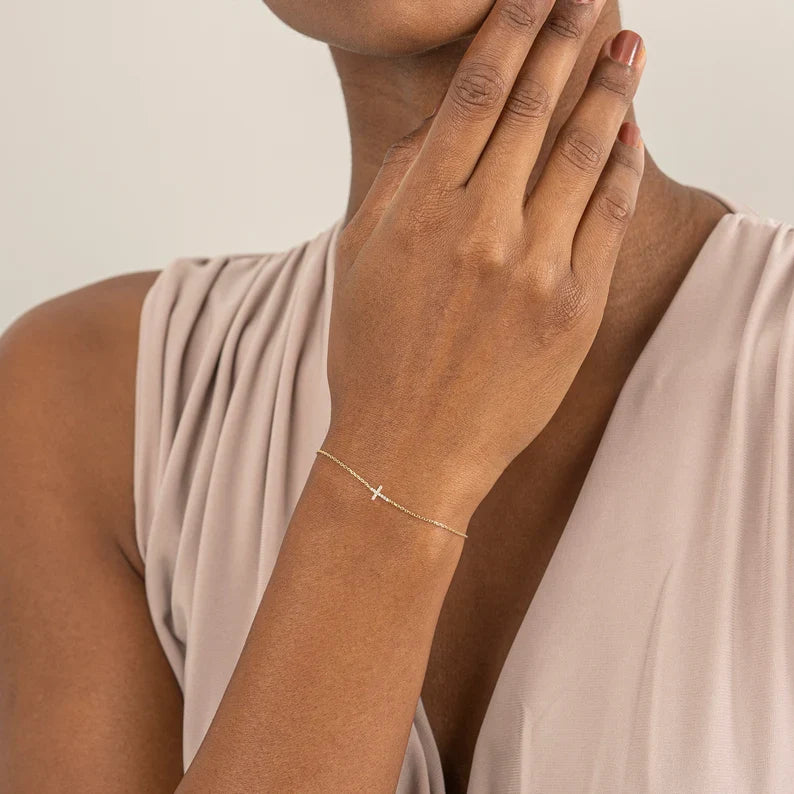 Close-up of zircon crystal cross on bracelet