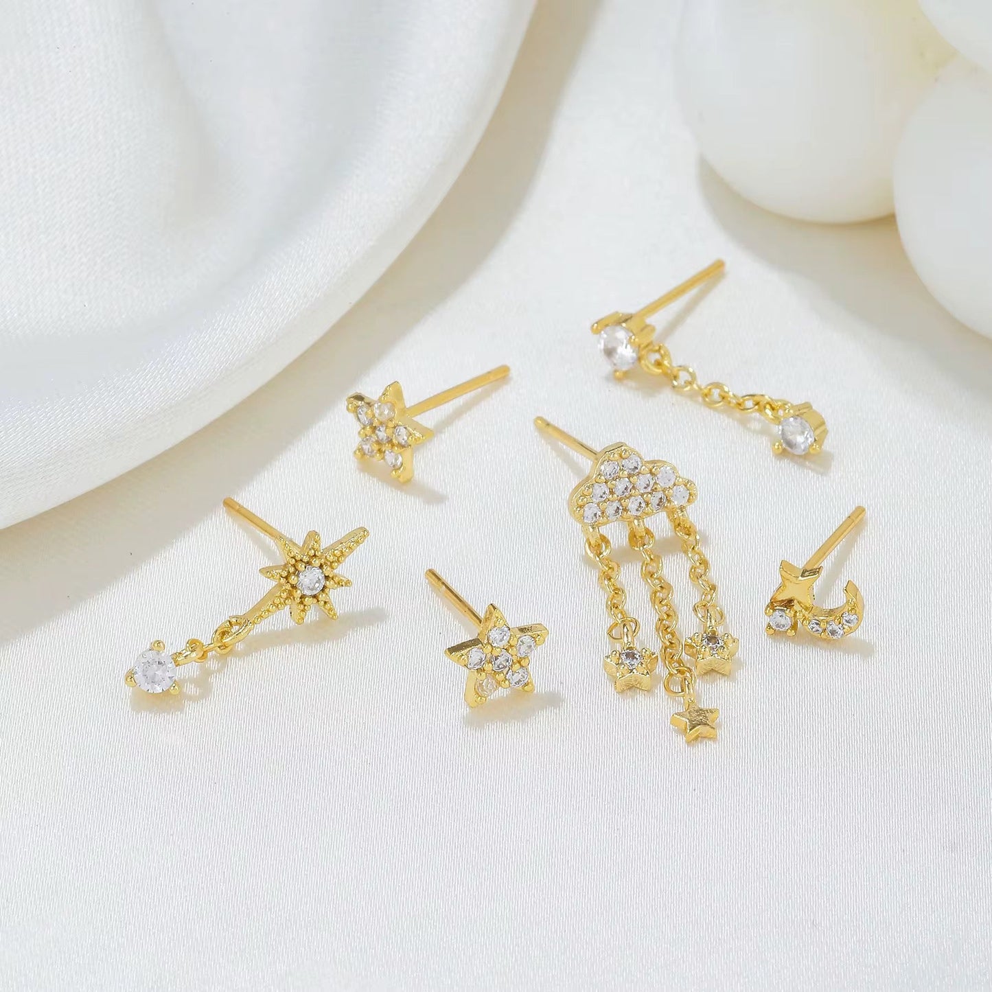 Cloud and star earrings styled for mix-and-match looks