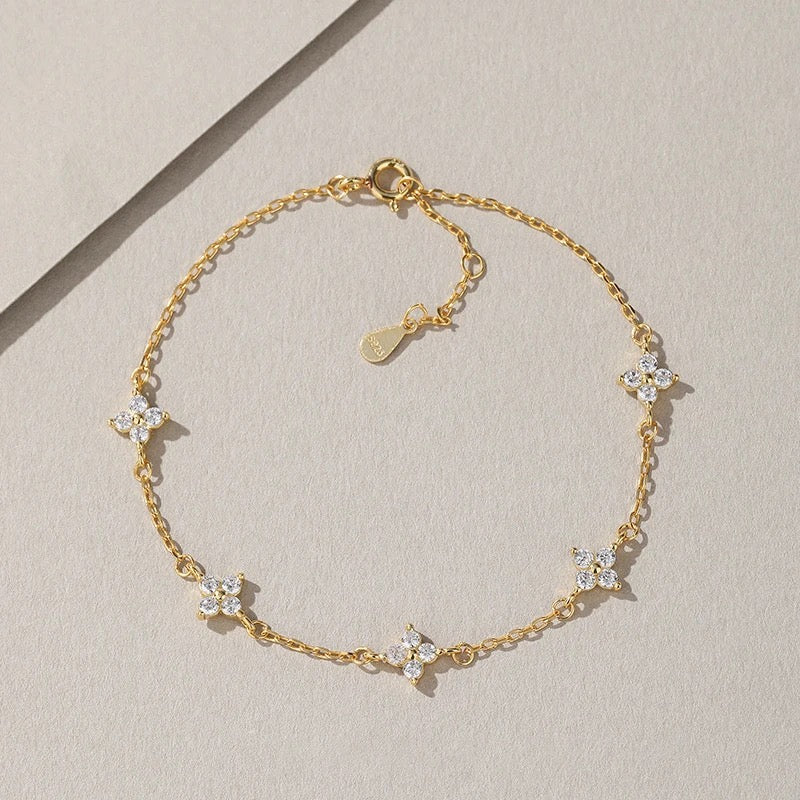 Close-up of clover bracelet with zircon crystals