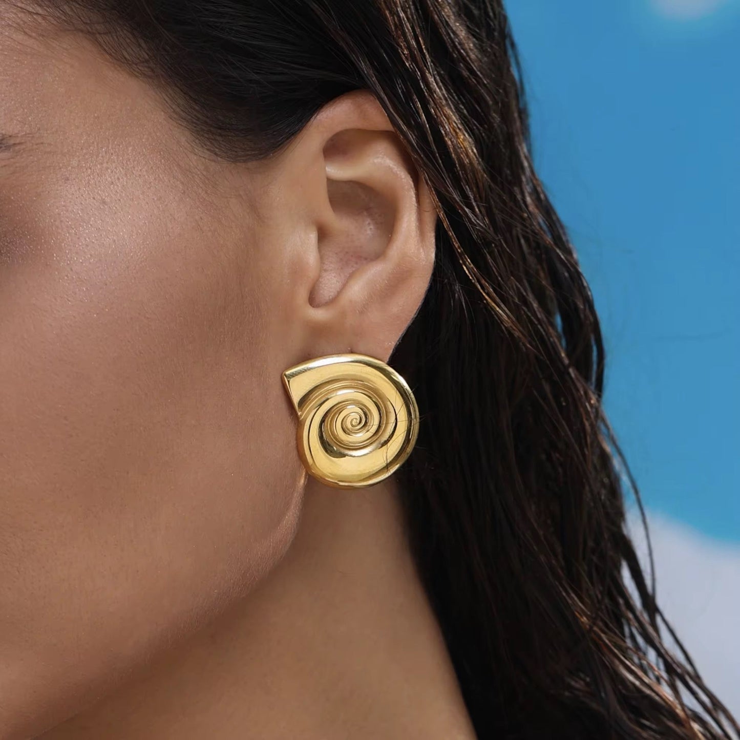 Conch-inspired shell earrings styled with beach outfit