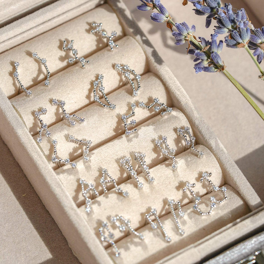 Constellation earrings layered with other earrings