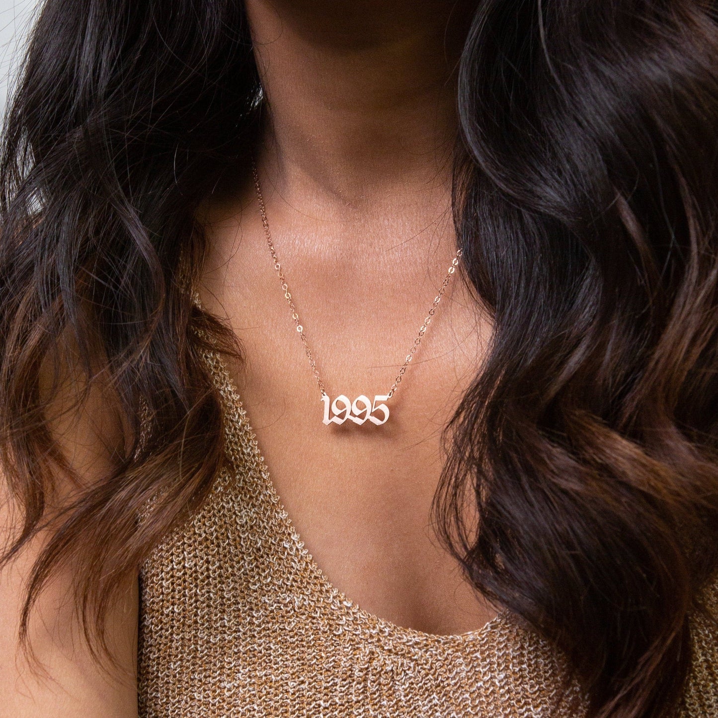 Custom year necklace layered with other chains