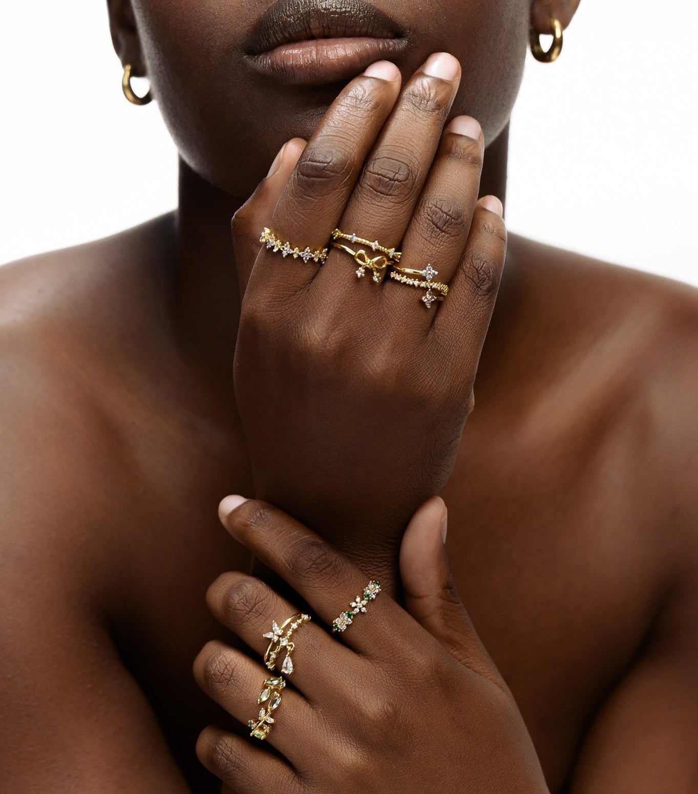 Dainty gold bow tie ring worn on hand