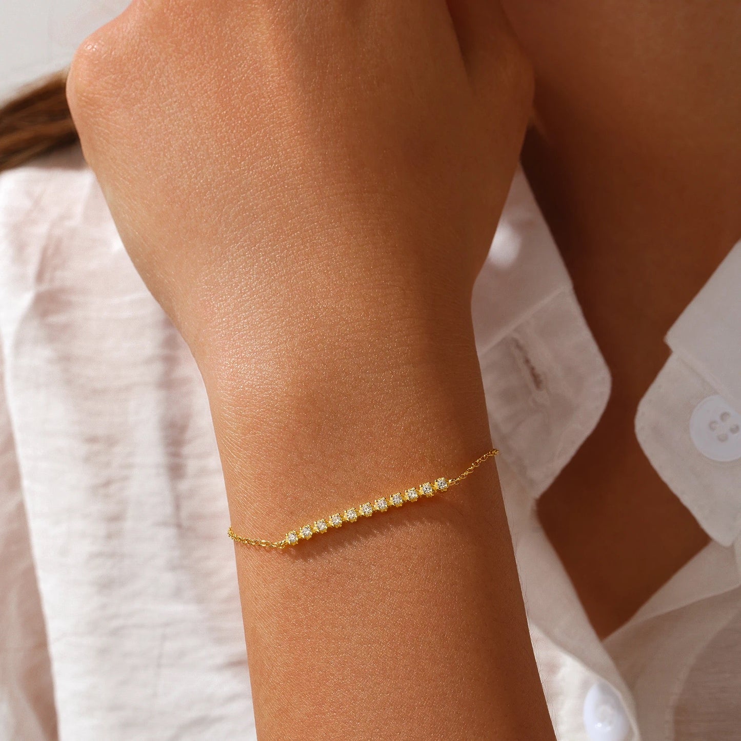 Dainty crystal bracelet layered with other jewelry – Loveness
