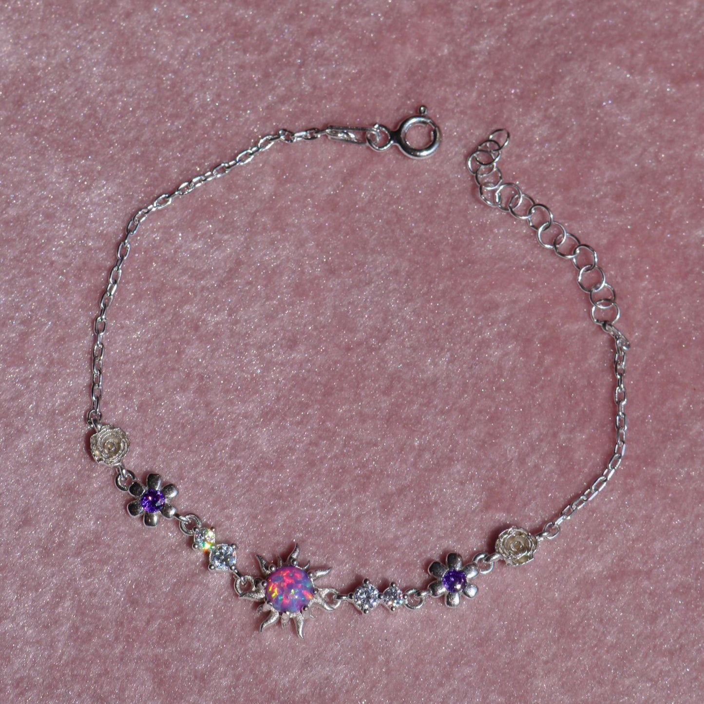 Delicate silver bracelet with glowing opal charm