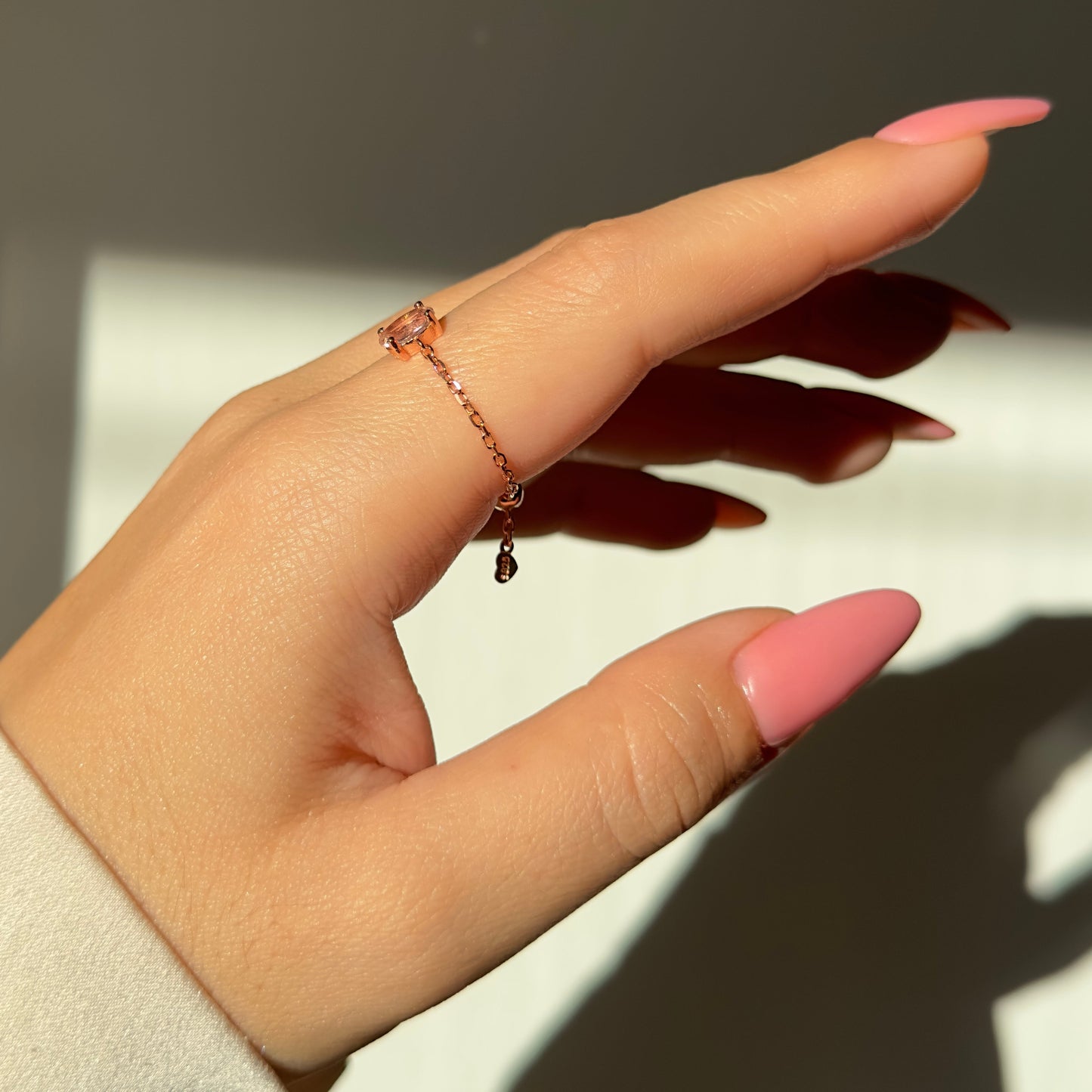 Adjustable chain ring with dusty pink cubic zirconia