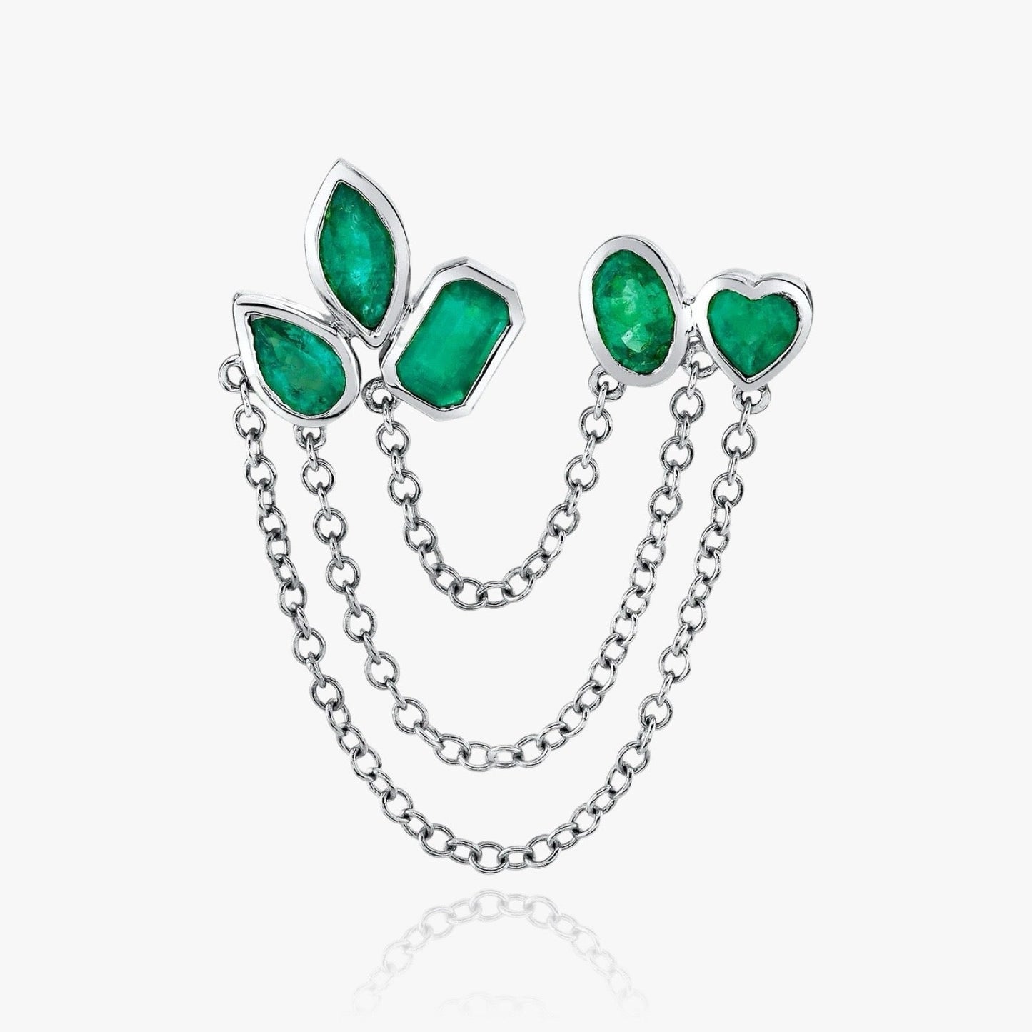 Close-up of emerald green chain earrings with silver finish