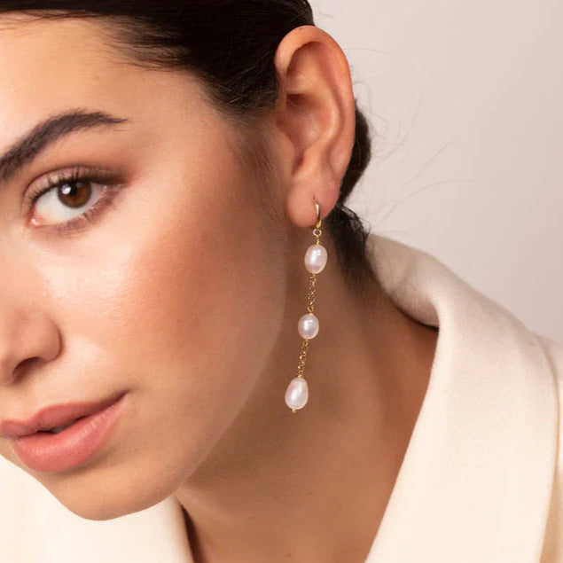 Close-up of irregular pearls on gold-plated hoops