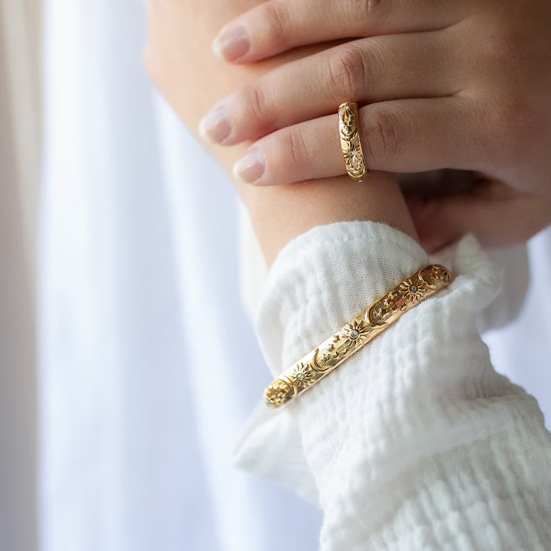 Gold bangle bracelet with sun and moon engraving