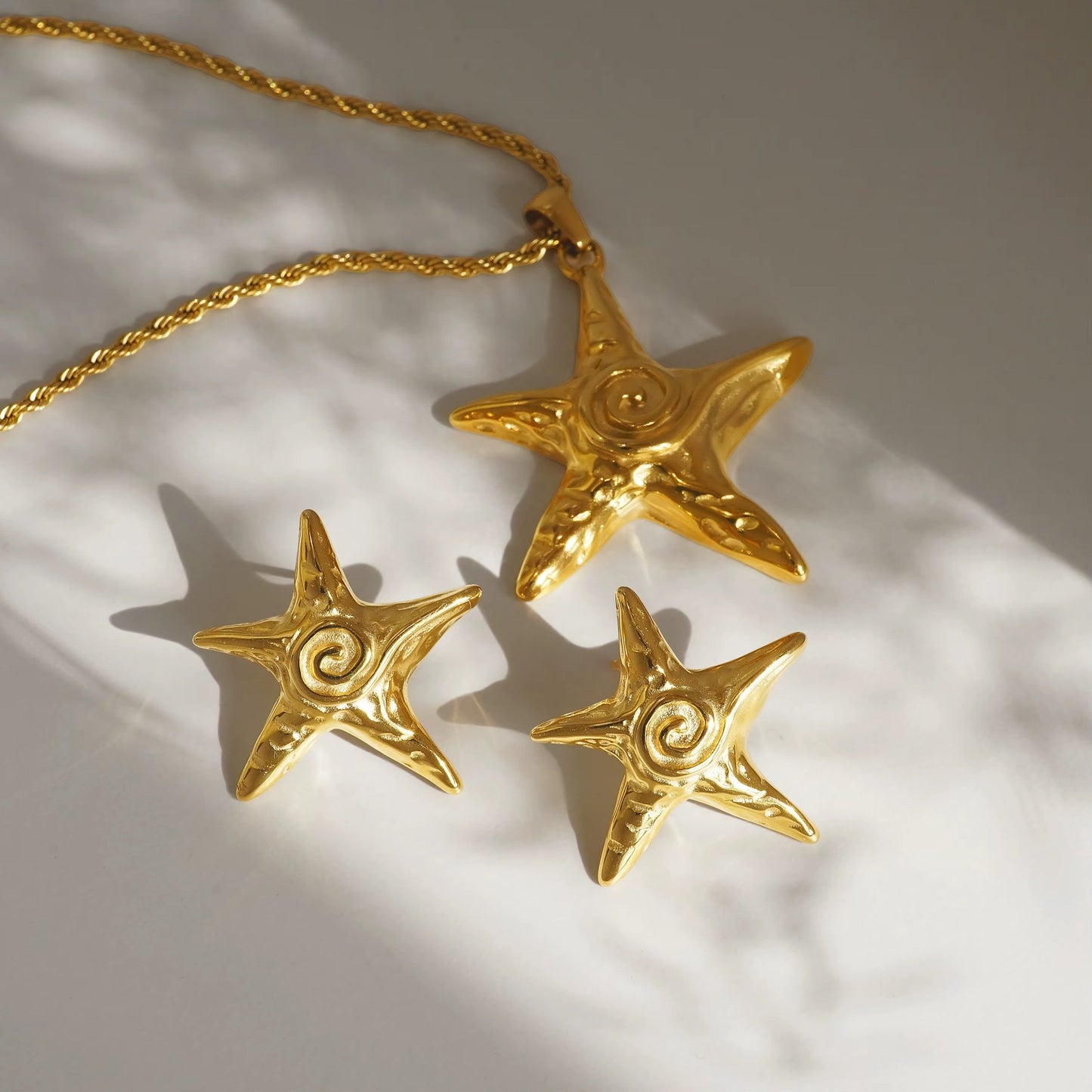 Detail of gold Hypno Starfish Necklace with pearl charm