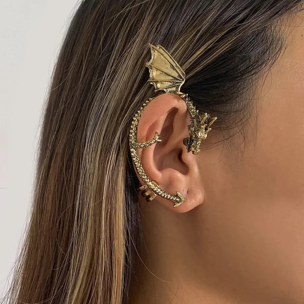 Close-up of Halloween dragon ear cuff in gold finish