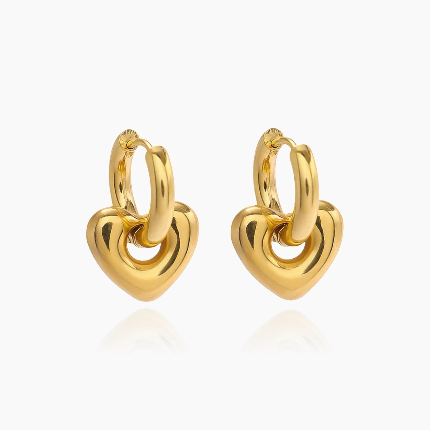 Front view of heart huggie transformer earrings in gold