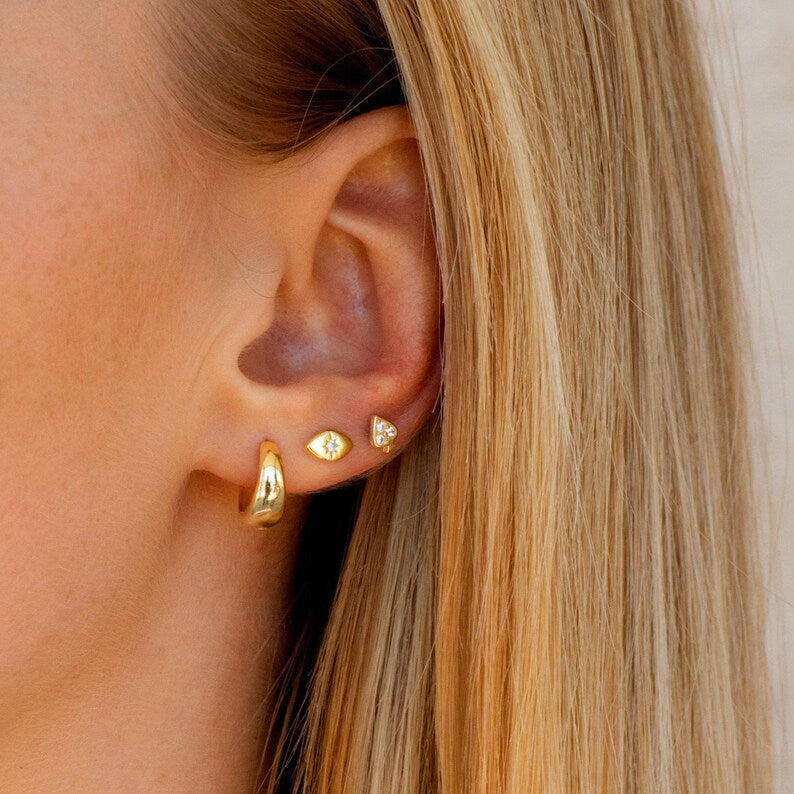 KAYA gold mini hoops worn on ear