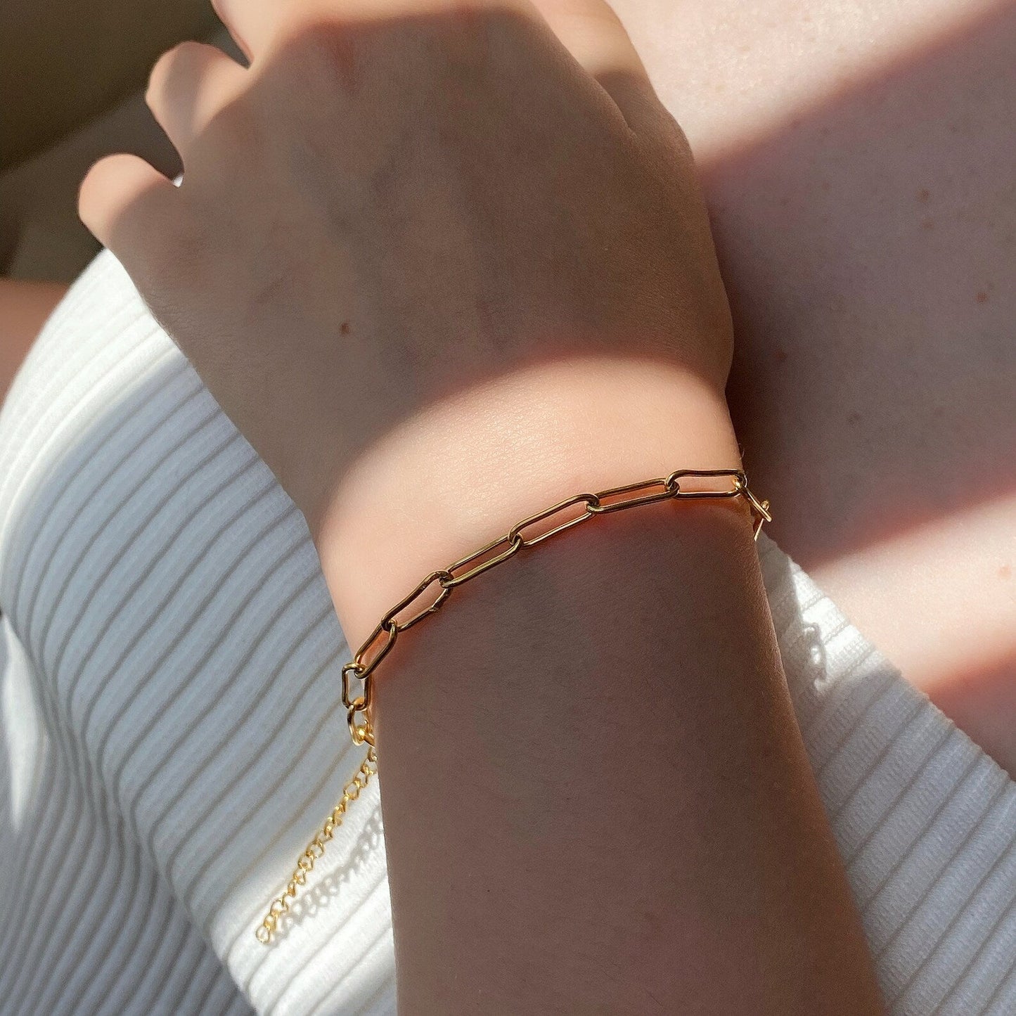 Layered gold paperclip chain bracelets