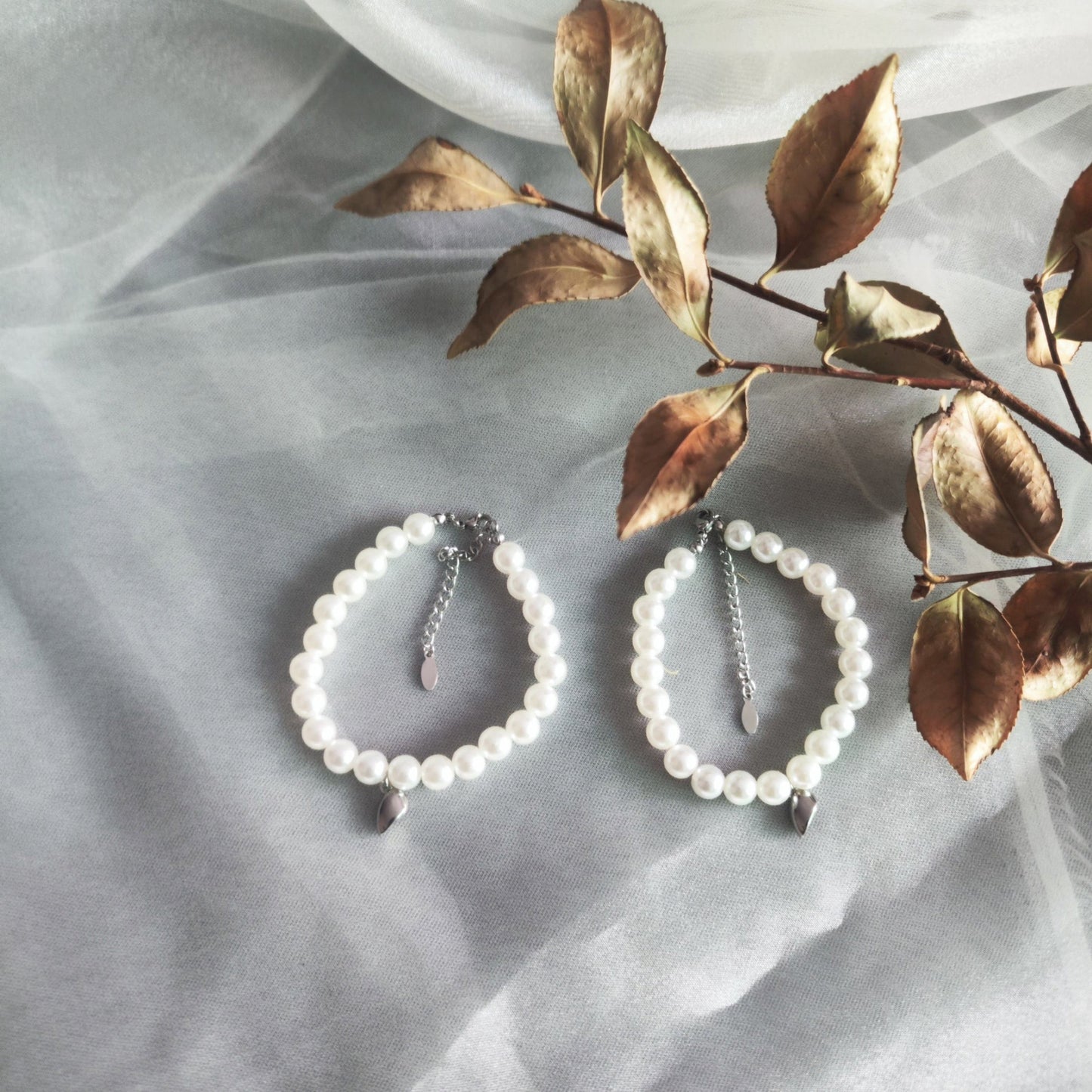 Romantic-themed flatlay with magnetic couple bracelets