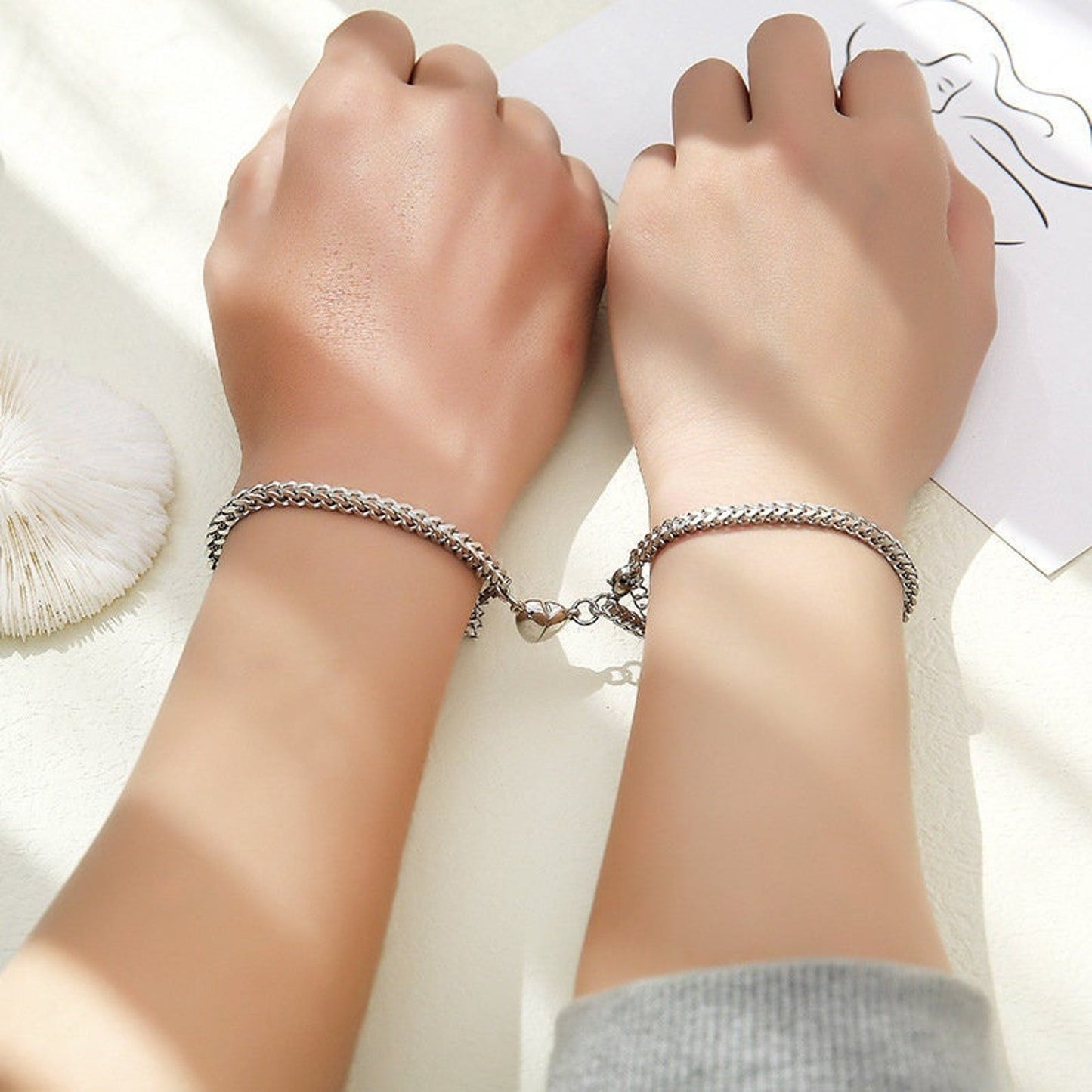 Magnetic bracelets forming a heart shape when joined