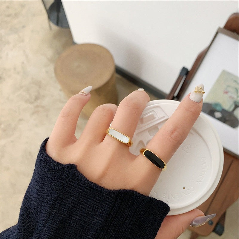 Elegant gold minimalist ring stacked with others