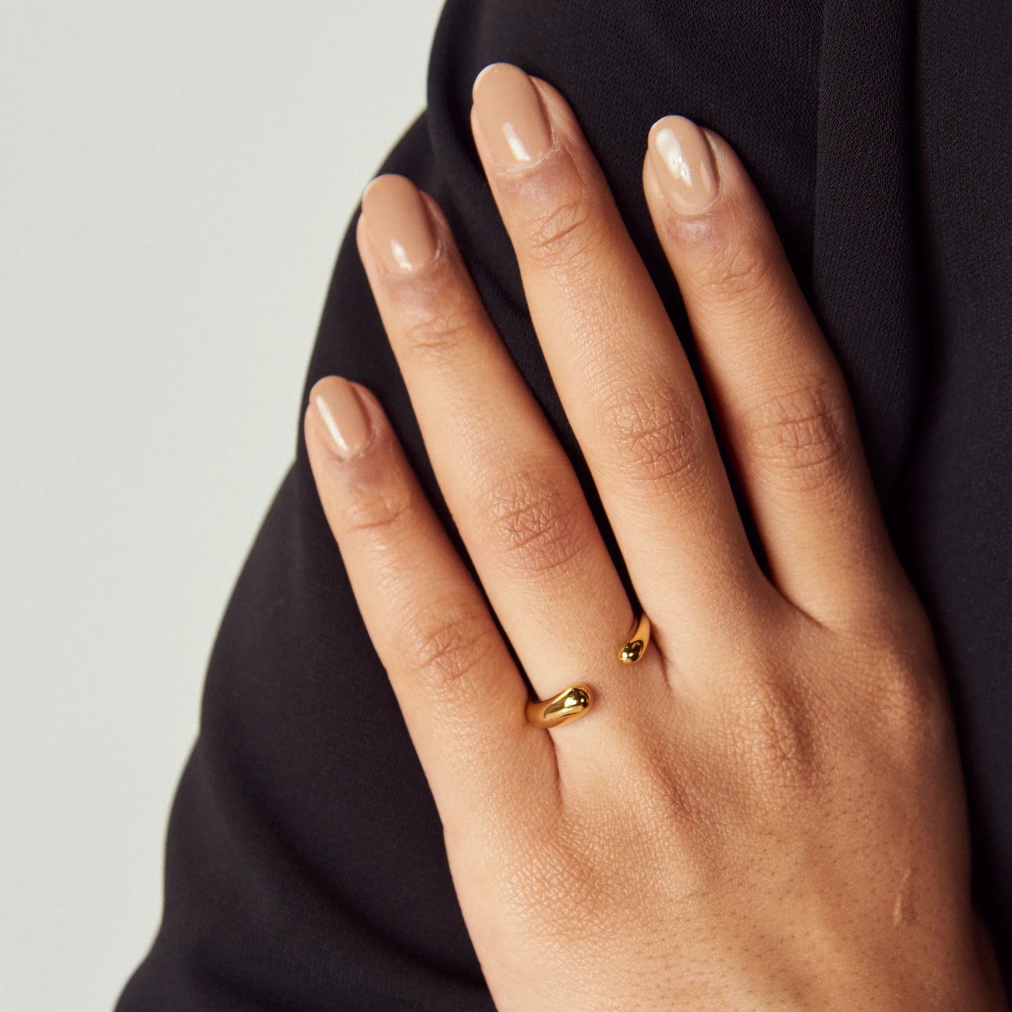 Minimalist wrap ring styled with other gold or silver rings