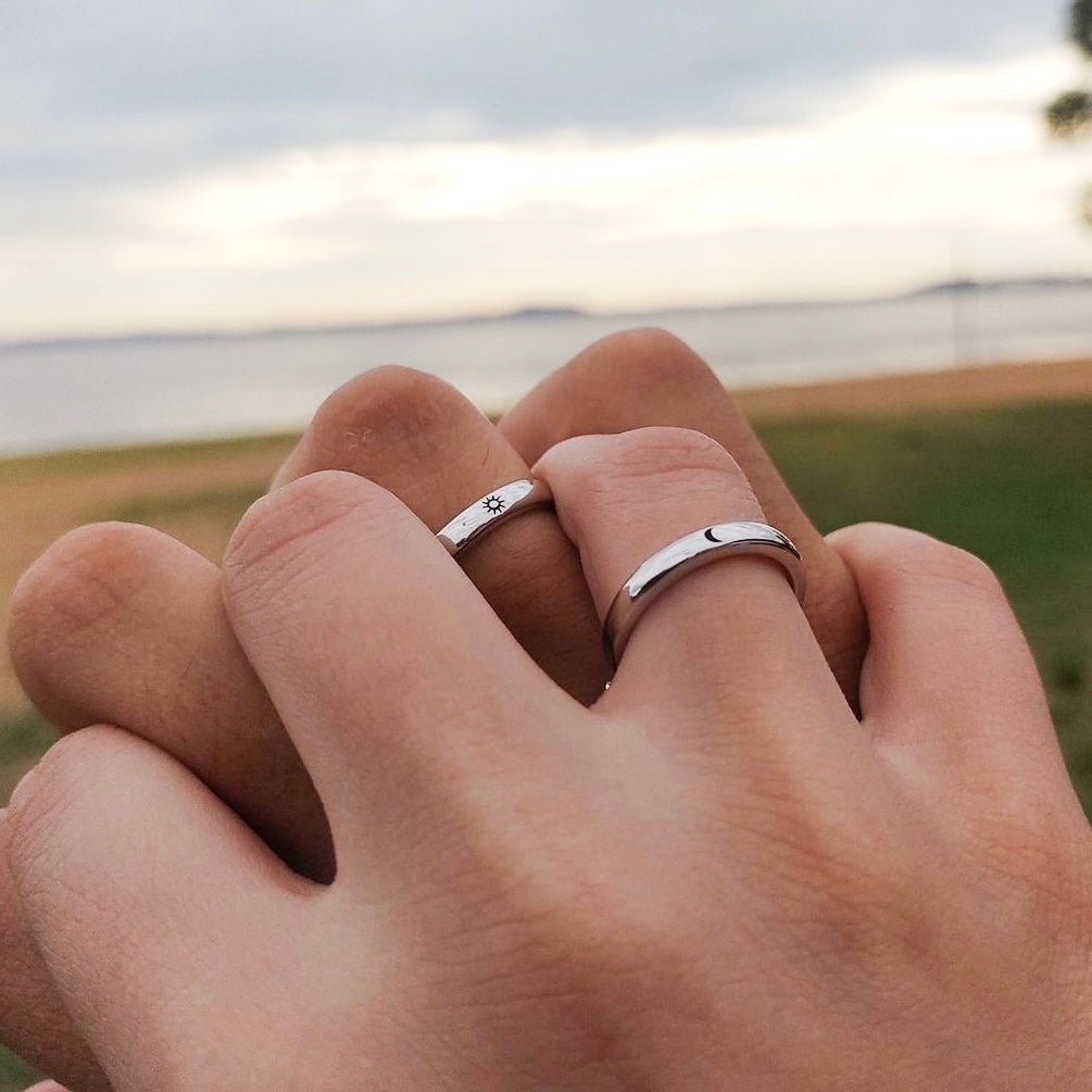 Matching Moon & Sun rings styled on couple’s hands