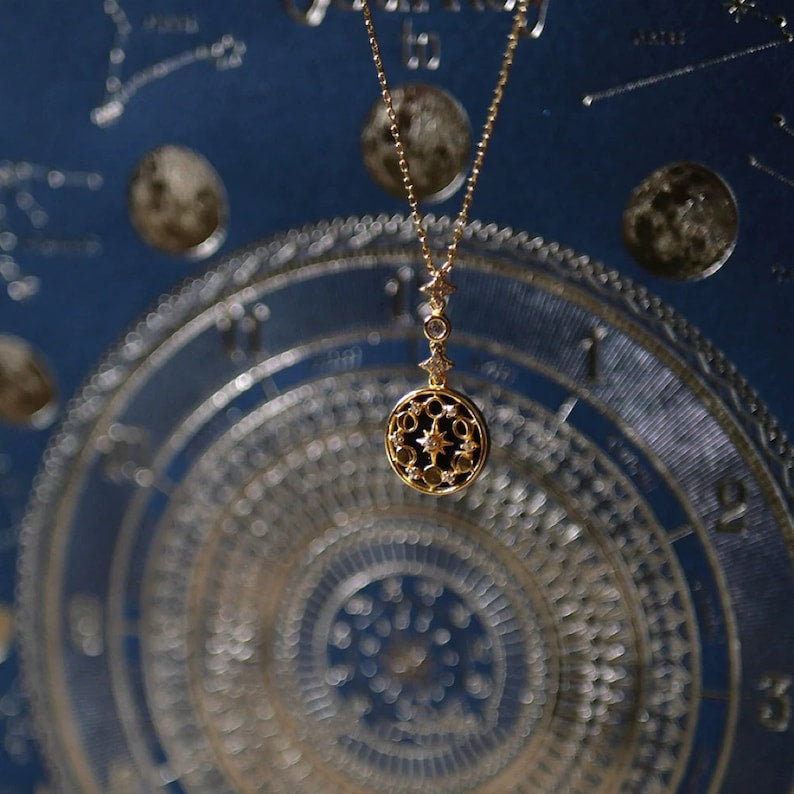 Flatlay of Moon Phase Necklace with blue gemstone