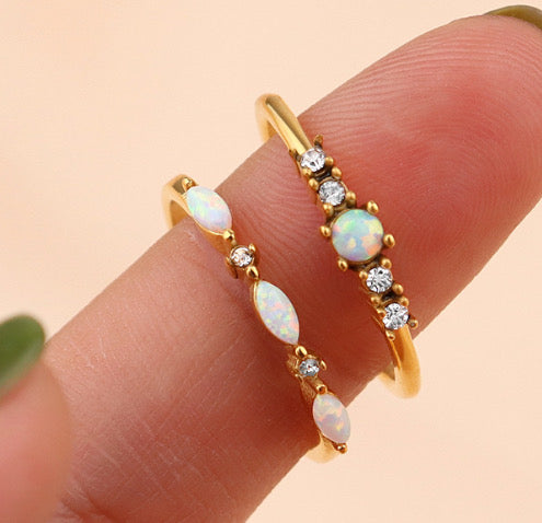 Opal ring in gold stacked with other rings