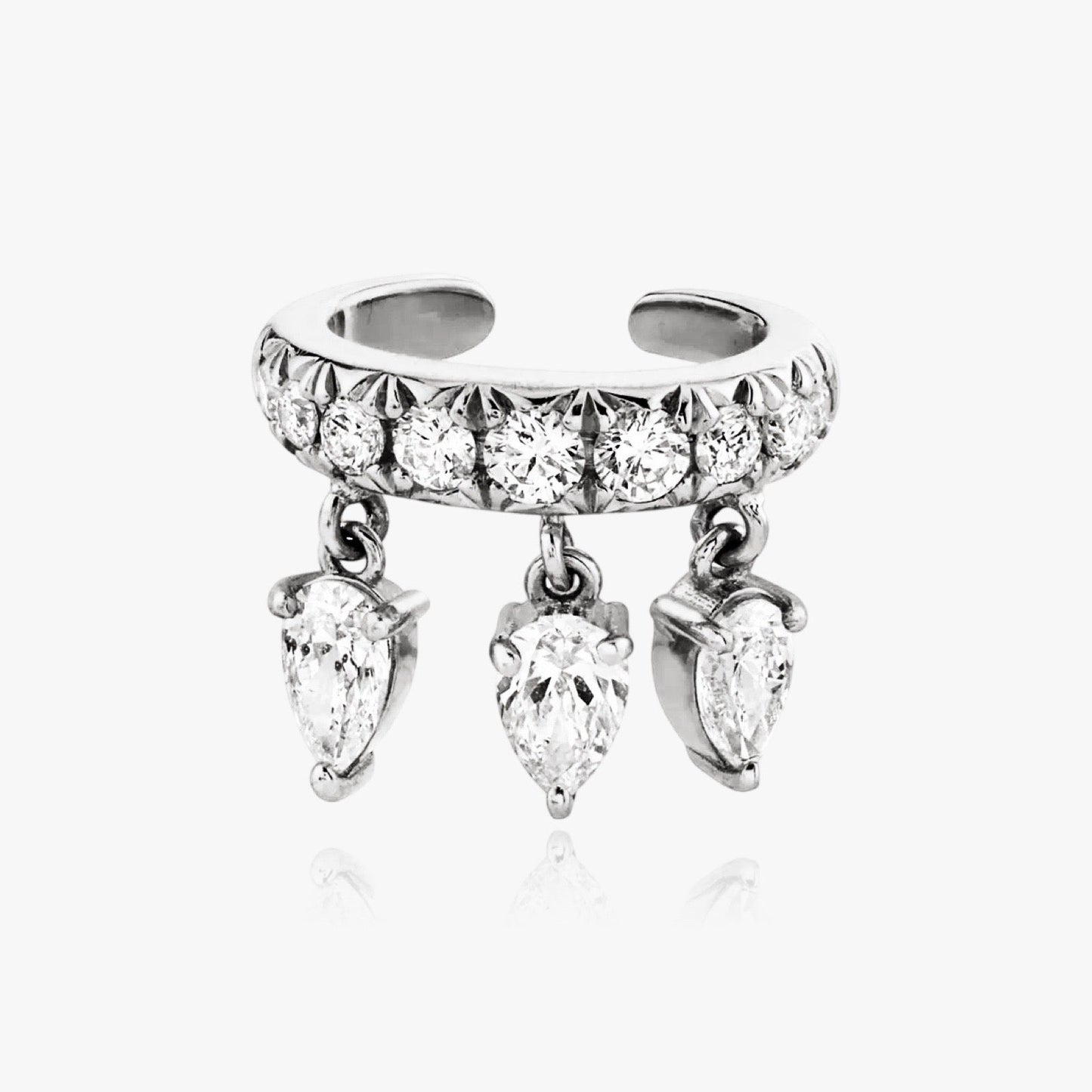 Close-up of pear cut zirconia on silver cuff earring