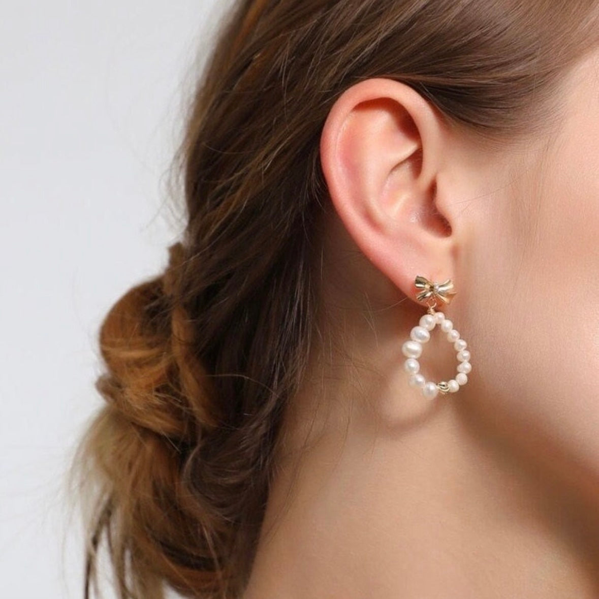 Elegant pearl bow earrings styled for a classic look