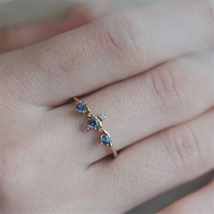 Sapphire ring stacked with other vintage-style rings