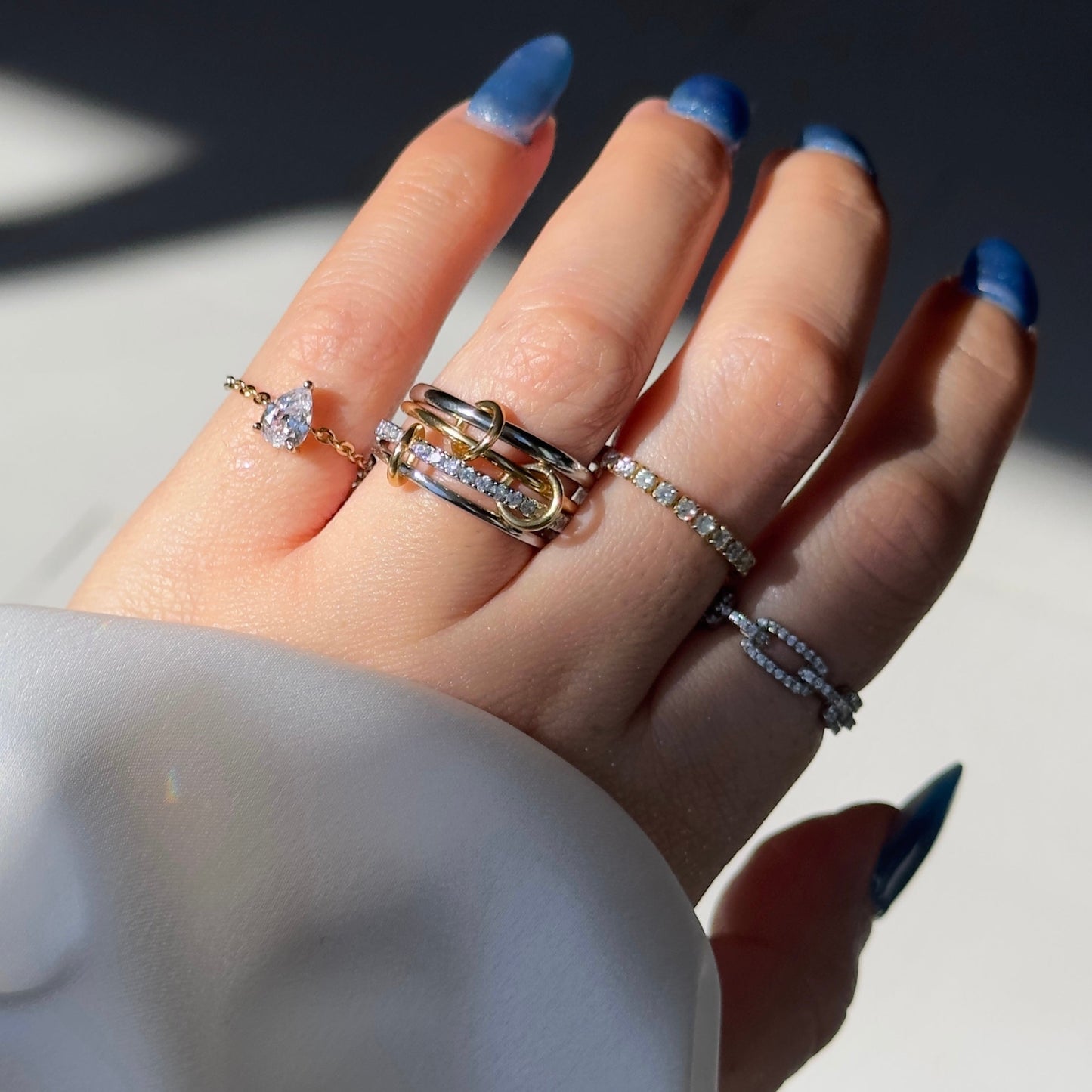 Stacked view of gold and silver self-love adjustable chain rings, showcasing versatility.