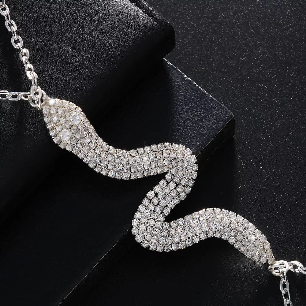 Snake body chain worn over crop top for bold look