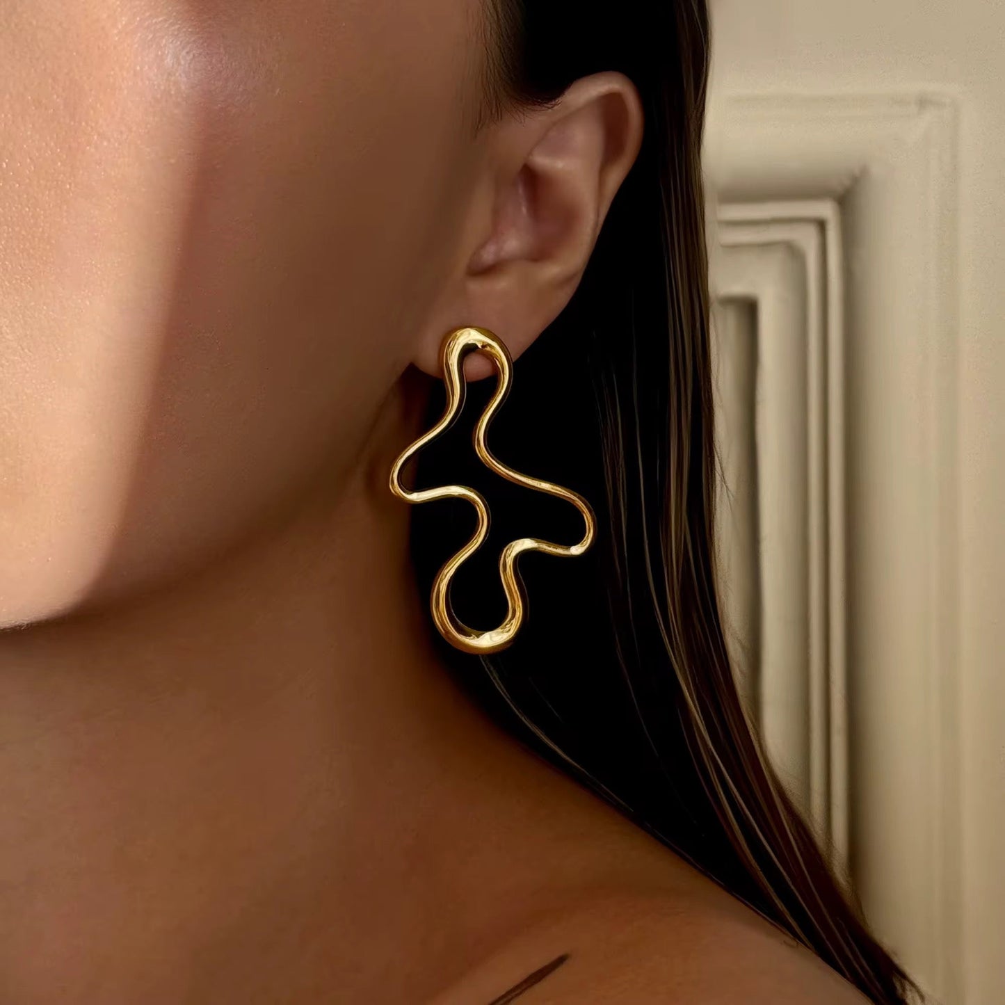 Side profile of contemporary art statement earrings