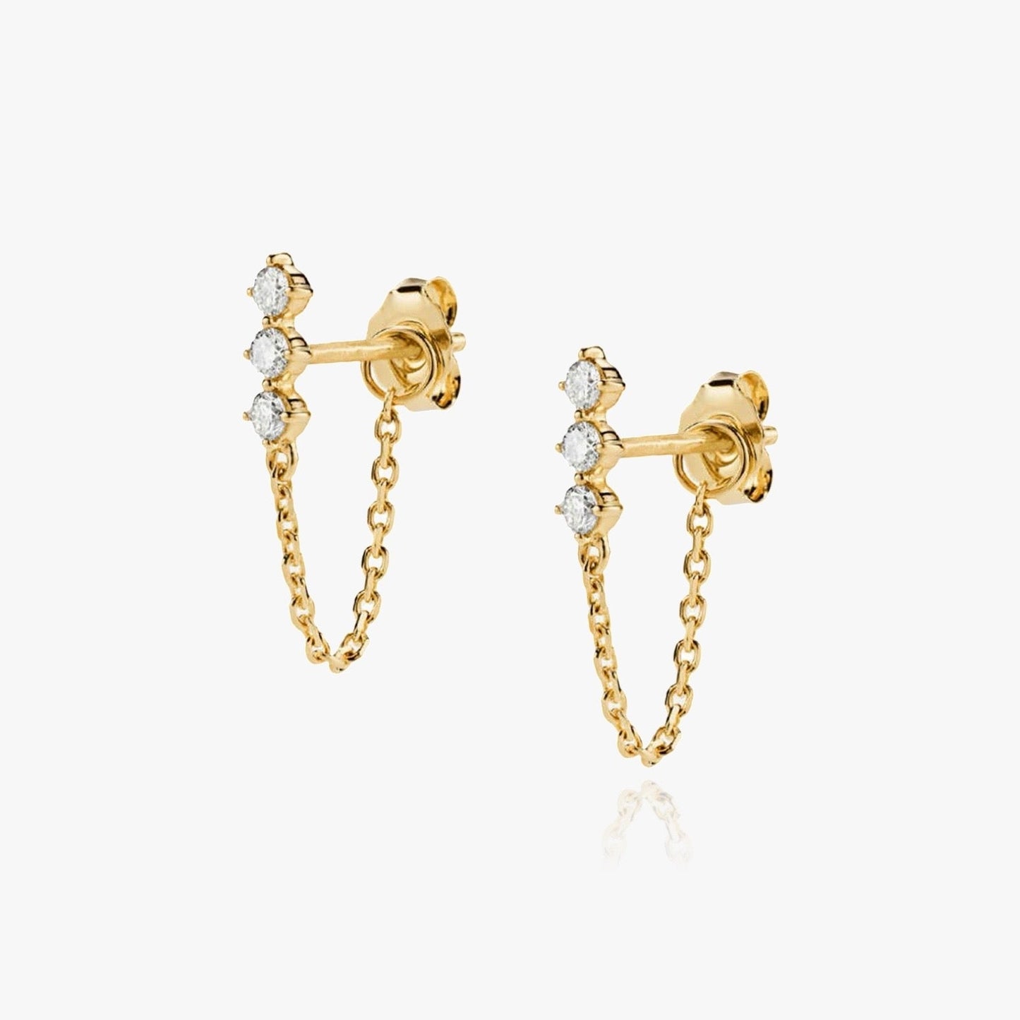Flatlay of Transformer chain earring with elegant jewelry