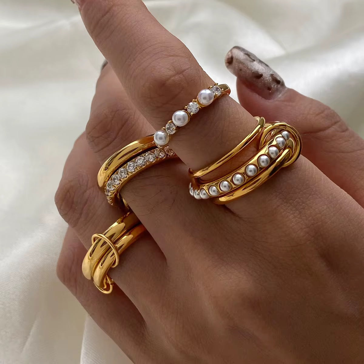 Fidget ring with triple pearls worn on finger
