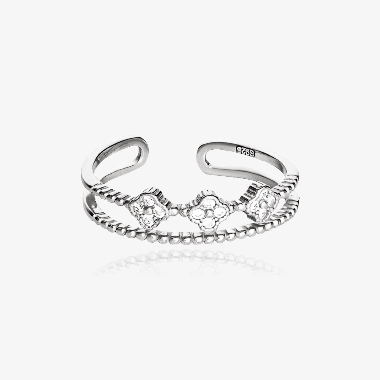 Waterproof clover ring shown in dainty lifestyle setting