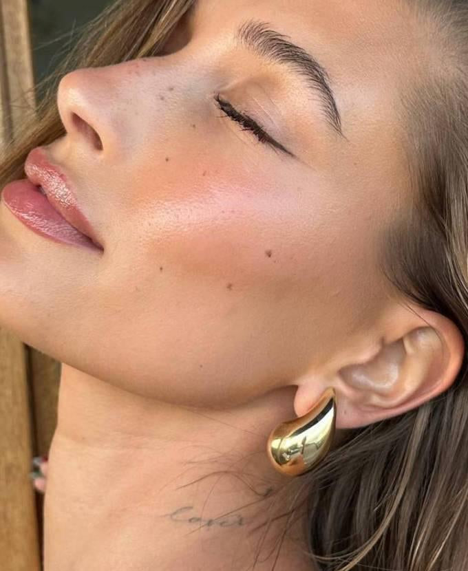 Droplet earrings styled in waterproof jewelry look