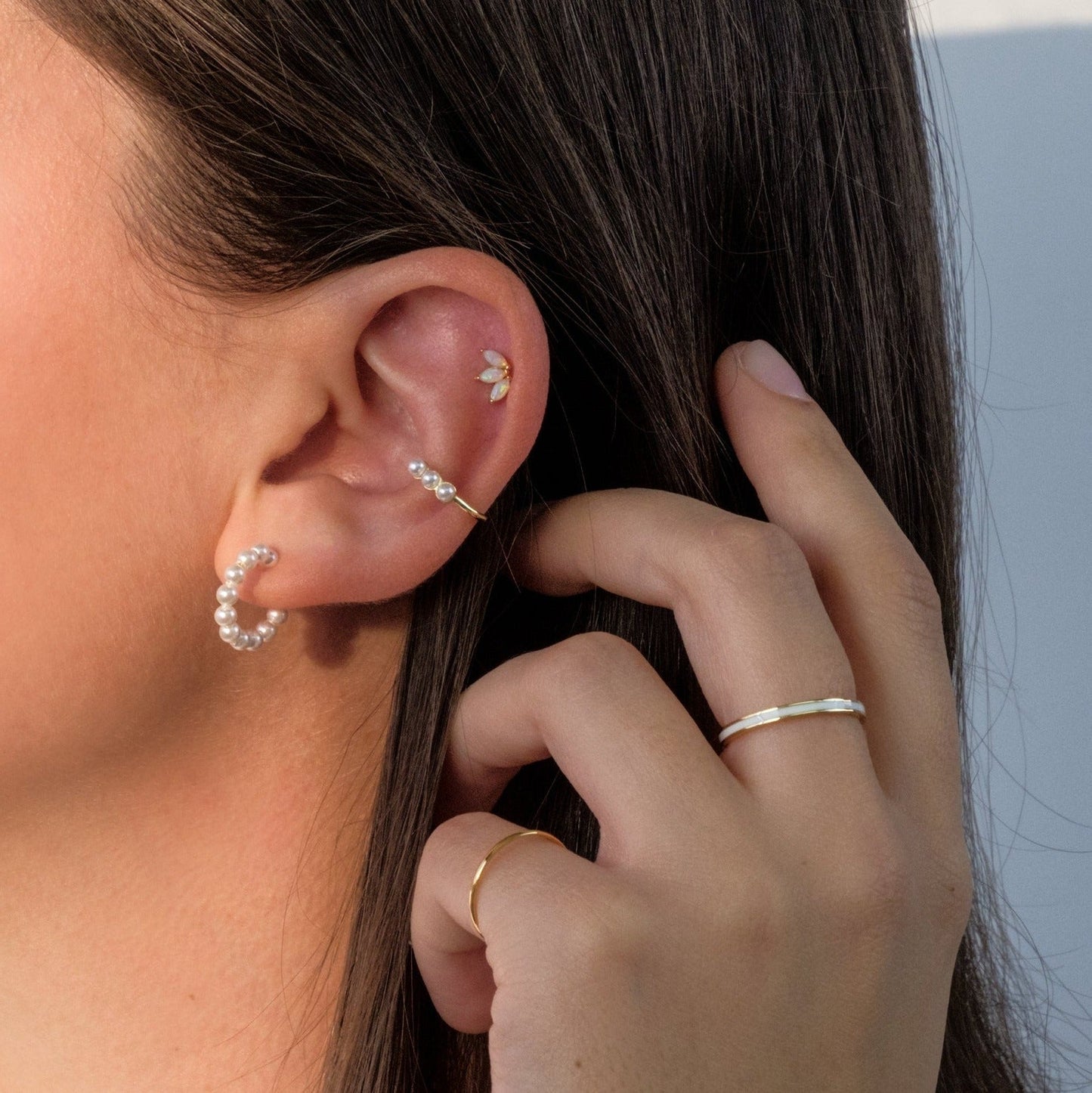 Waterproof 18K gold pearl earrings shown in test