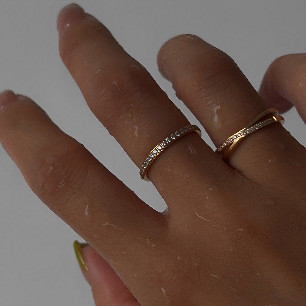 Close-up of waterproof X-shaped pavé ring