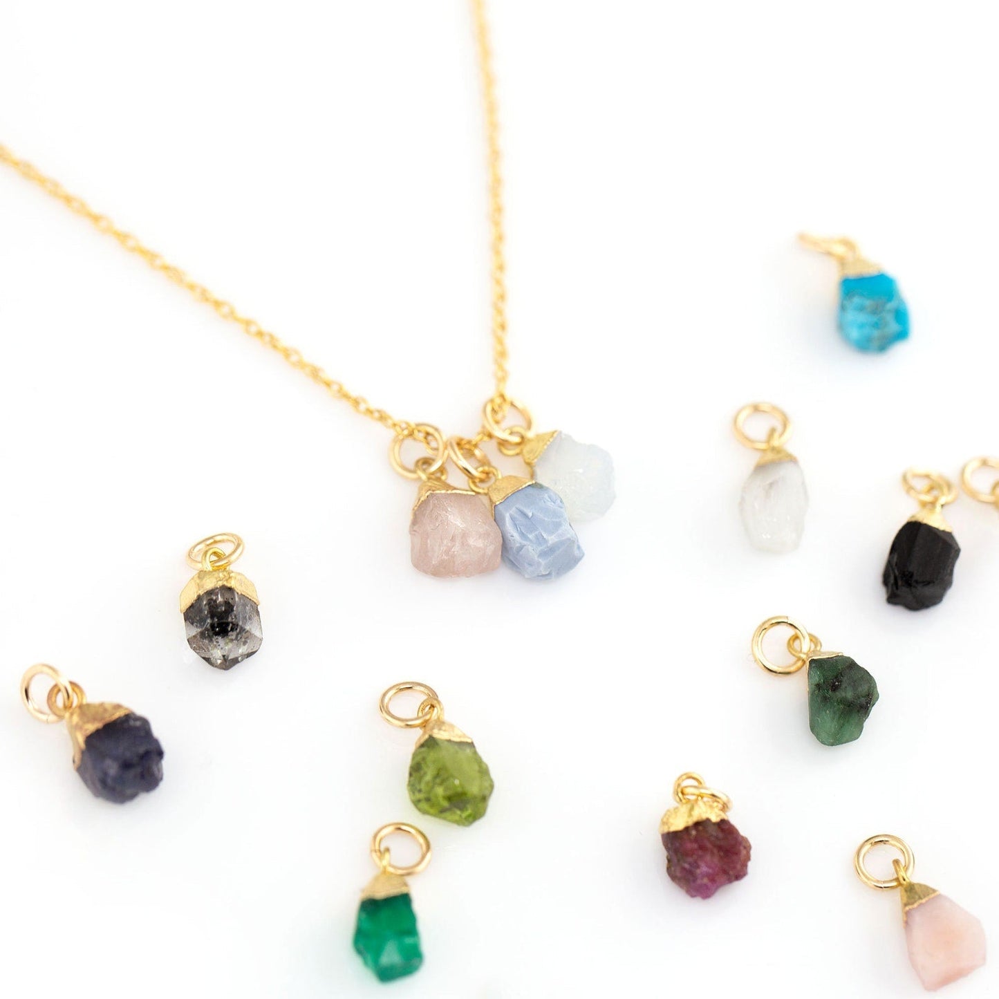 Zodiac birthstone necklace styled with other gold jewelry