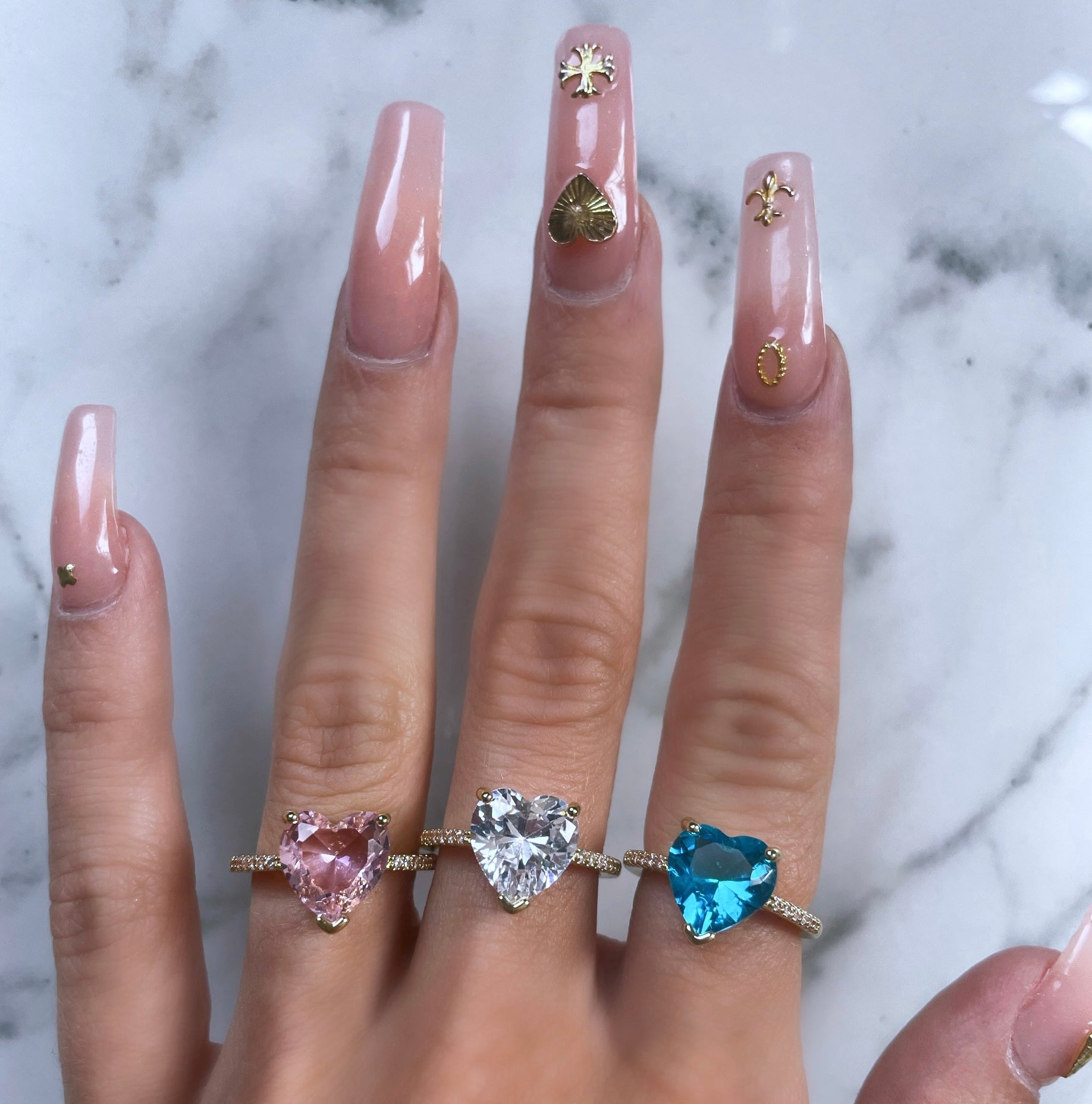 Amour gold heart ring styled on a hand