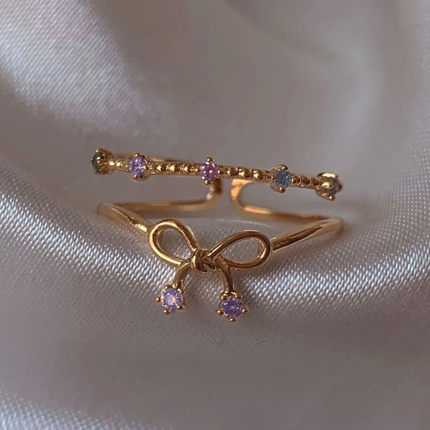 Bow tie ring stacked with other rings – elegant look