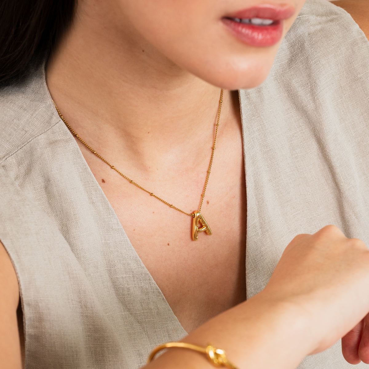 Bubble Initial Halskette Gold am Hals getragen