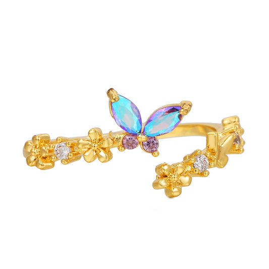 Butterfly ring stacked with other delicate gold rings
