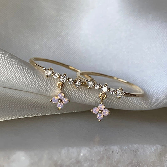 Front view of dainty clover charm ring with crystal detail