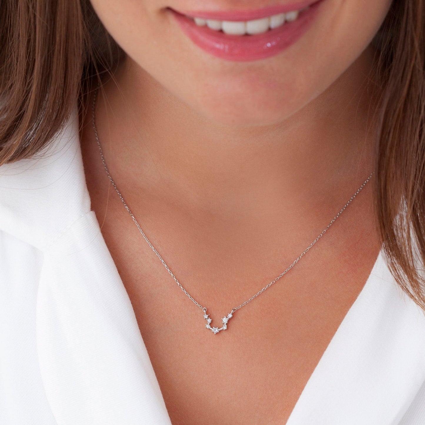 Zodiac constellation jewelry styled in layers
